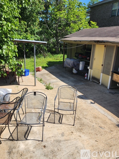 A patio with two chairs and a table.