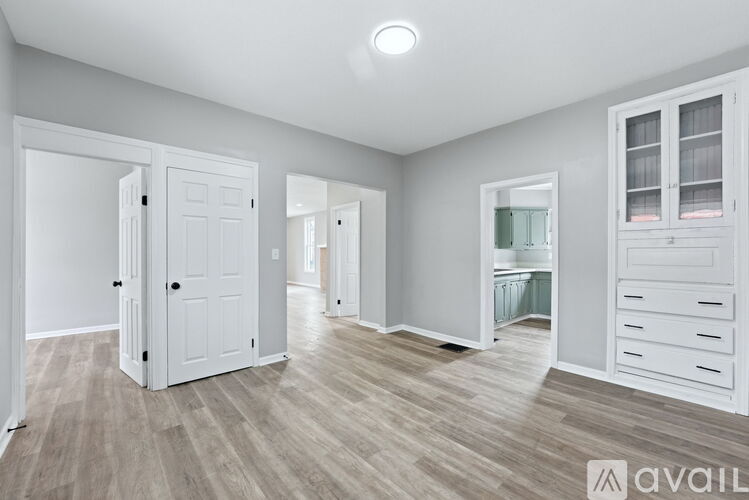 A spacious room with white doors and drawers.