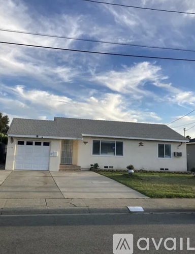 A house with a garage and a driveway in front.