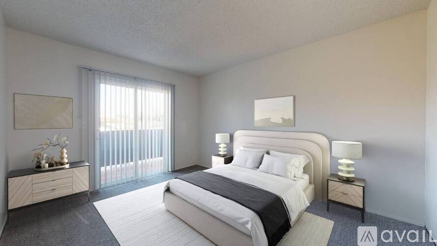 A bedroom with a large bed, a nightstand, and a dresser with a mirror.