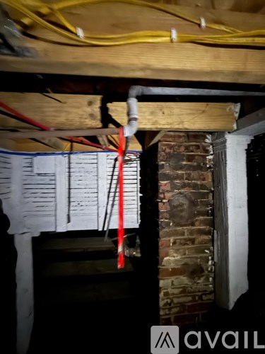 A white sign with red and black text is hanging on a wall.