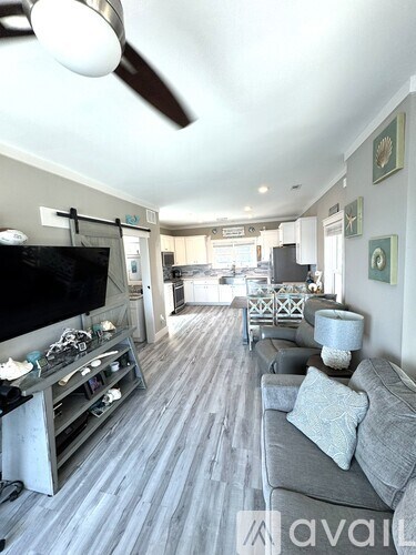 A living room with a grey couch and a television.