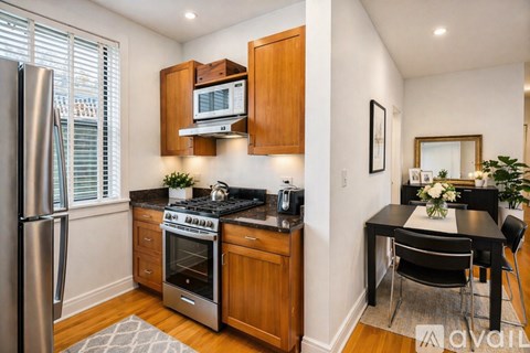 A kitchen with wooden cabinets and a black stove top.