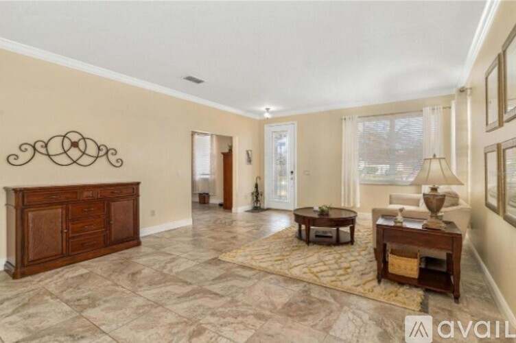A living room with a wooden cabinet and a rug on the floor.