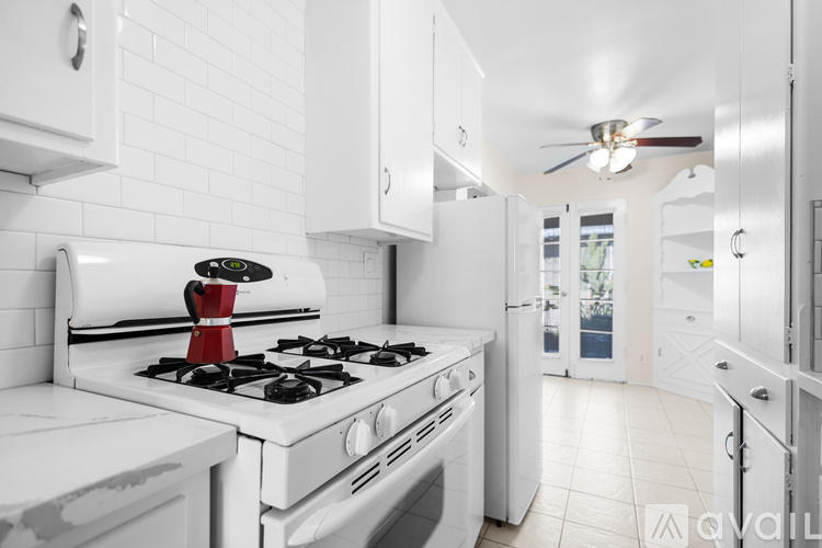A white kitchen with a stove and a toaster.