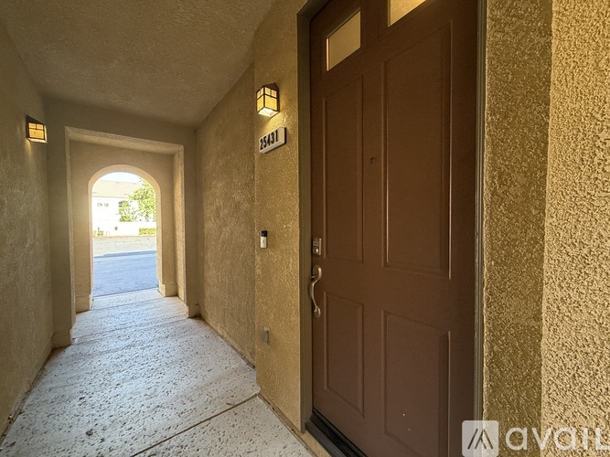 A hallway with a brown door and a sign that says 15411.