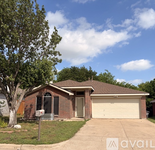 A house with a brown roof and a white garage door is for sale.