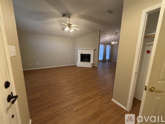 A room with a fireplace and a ceiling fan.