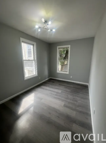 A room with grey walls and wooden flooring.