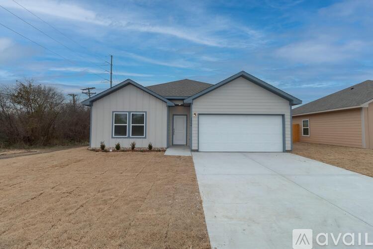 A two-story house with a garage is available for sale.