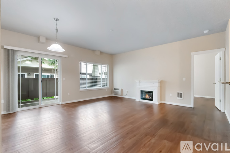 A spacious living room with a fireplace and sliding glass doors.