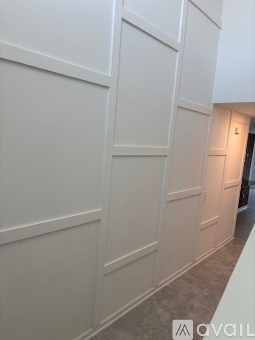 A white wall with a logo that says "avail" on it.