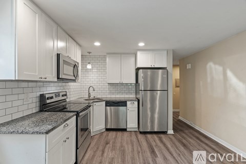 A kitchen with white cabinets and stainless steel appliances.