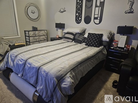 A bedroom with a large bed and a wall decorated with footprints.