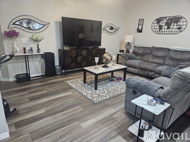 A living room with a grey couch and a wooden coffee table.