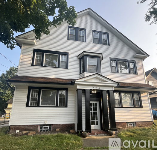 A two-story house with a white front and black trim.