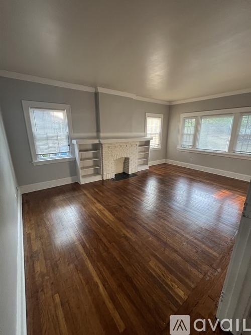 A room with wooden floors and a fireplace.