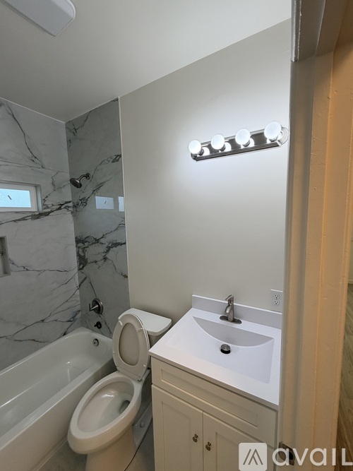 A bathroom with a marble floor and a white sink.