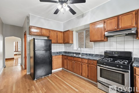 A kitchen with wooden cabinets and black appliances.