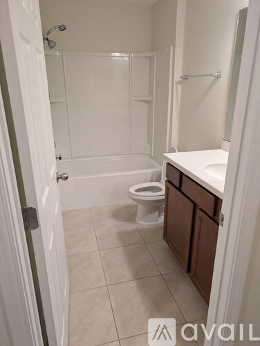 A bathroom with a toilet, sink, and bathtub.