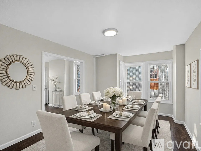 A dining room with a table set for six.
