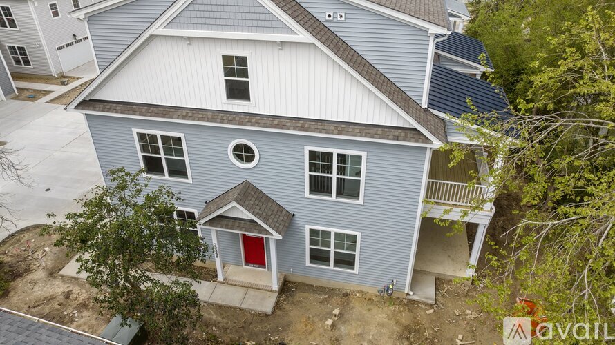 A house with a red door is for sale.