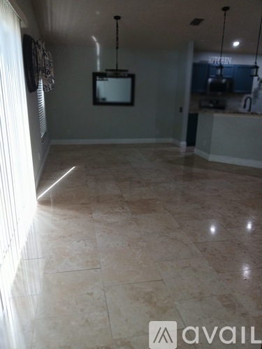 A room with a tiled floor and a television mounted on the wall.