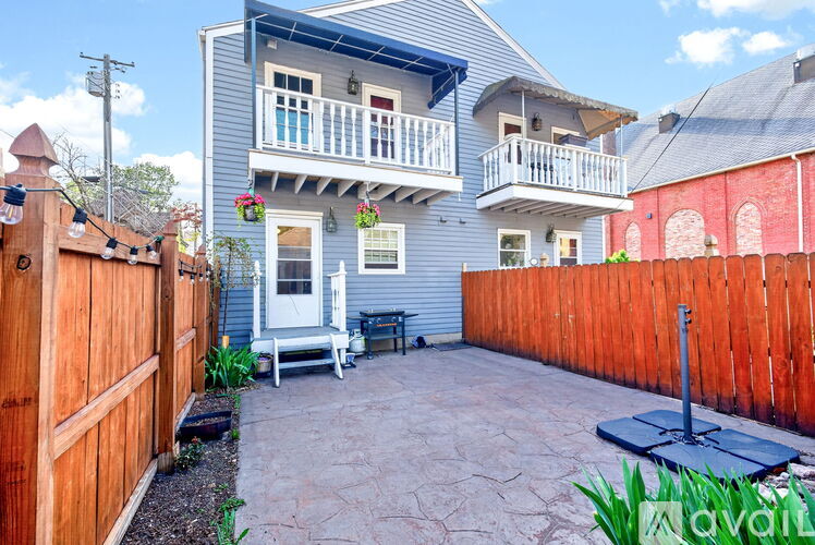 A house with a blue exterior and a wooden fence.