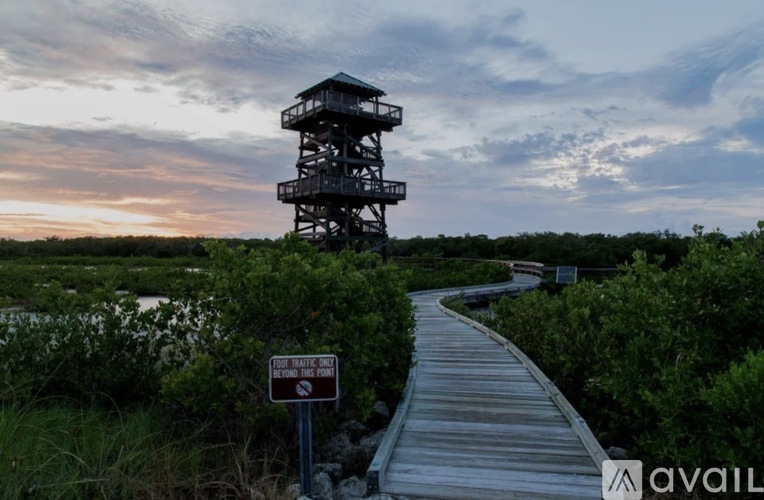 A wooden walkway leads to a tall observation tower with a sign that reads "End State Park".