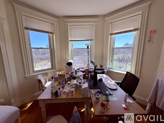 A room with a desk and a chair in front of a window.