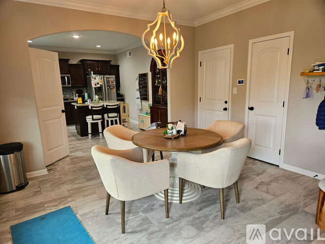 A spacious room with a staircase and a carpeted floor.