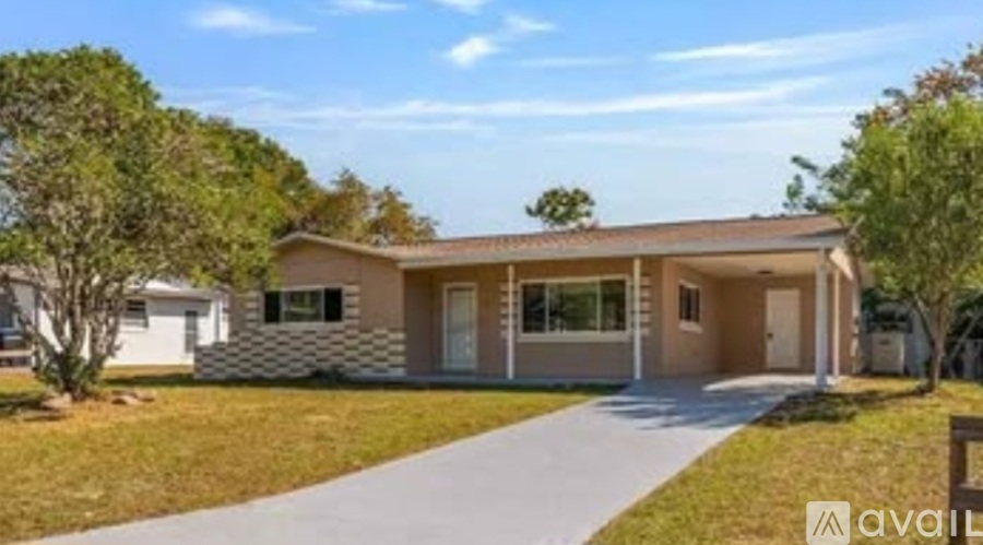 A modern house with a brown roof and a white fence is for sale.