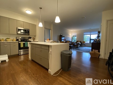 A kitchen with wooden floors and a large island in the middle.