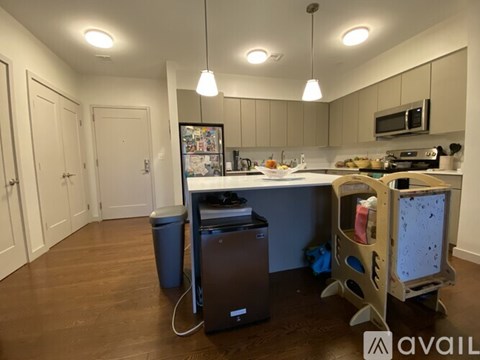 A kitchen with a dining table and chairs.