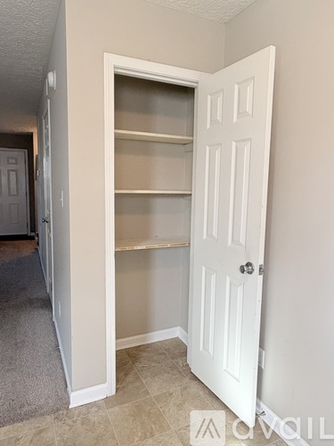 A white door with a glass panel is open in a room.