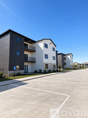 A row of townhouses with cars parked in front.
