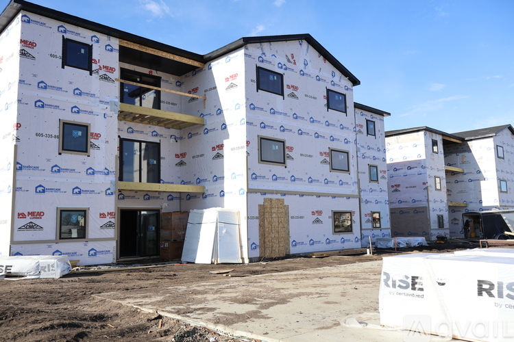 A building under construction with a RISE by Celanova sign in front.