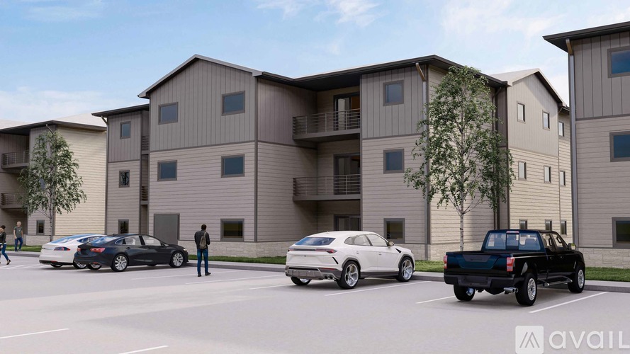 A row of townhouses with cars parked in front.