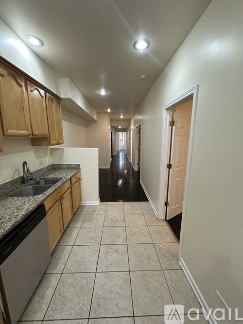 A kitchen with a sink and a dishwasher.