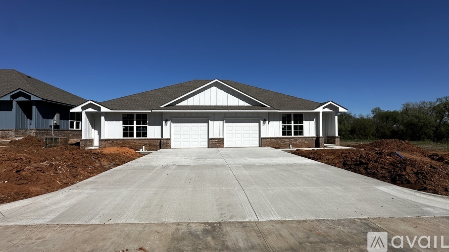 A large house with a driveway in front of it.