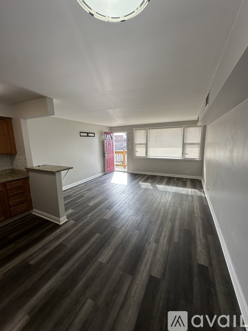 A room with wooden flooring and a skylight.