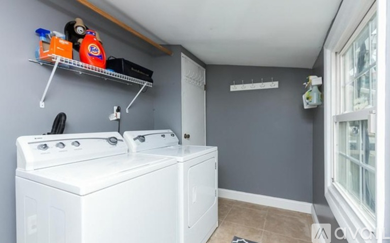 A small laundry room with a washer and dryer.