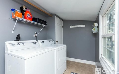 A small laundry room with a washer and dryer.