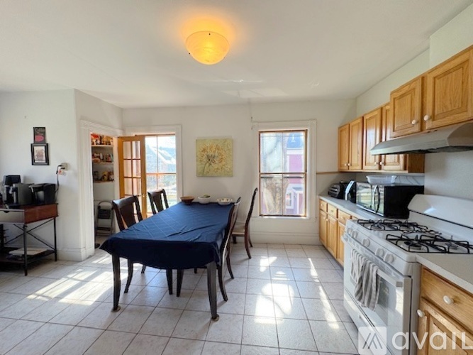 A kitchen with a table and chairs in the middle of the room.