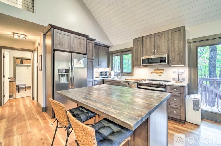 A modern kitchen with a wooden table and chairs.