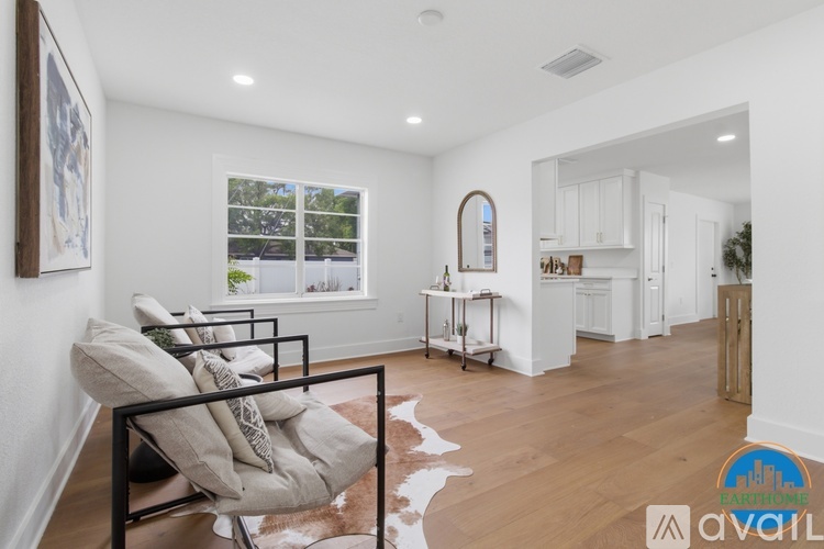 A living room with a couch and a cowhide rug.