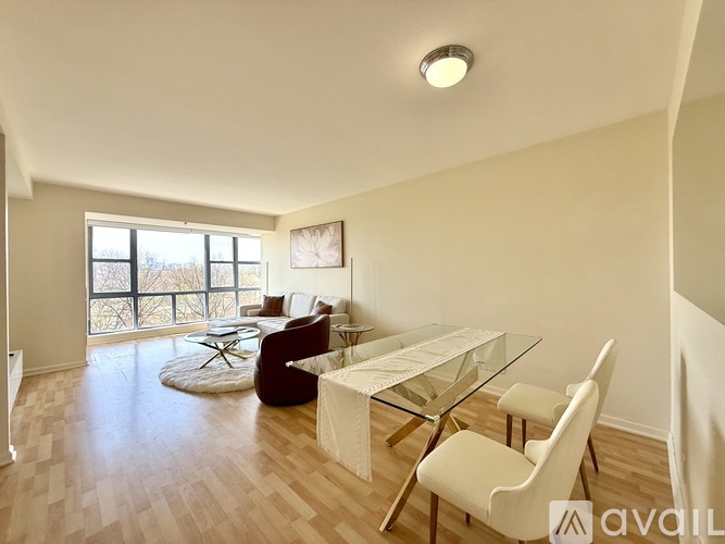 A living room with a glass table and chairs.