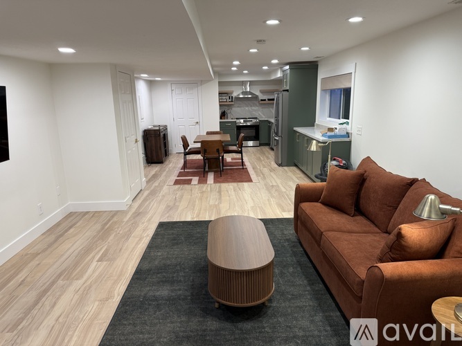 A living room with a brown couch and a wooden coffee table.