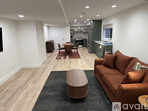 A living room with a brown couch and a wooden coffee table.