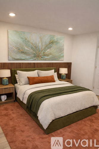 A bedroom with a large bed and a painting on the wall.